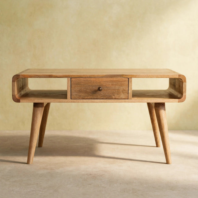 Rounded-edge coffee table with two drawers and shiny knobs in a room setting