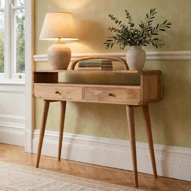 Curved oak-ish solid mango wood console table with two drawers in a hallway
