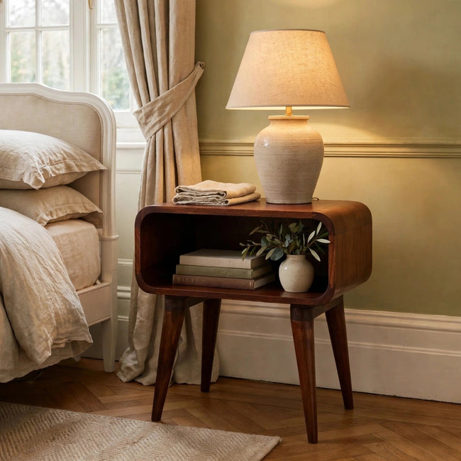 Chestnut solid mango wood bedside table with an open compartment, shown in a bedroom