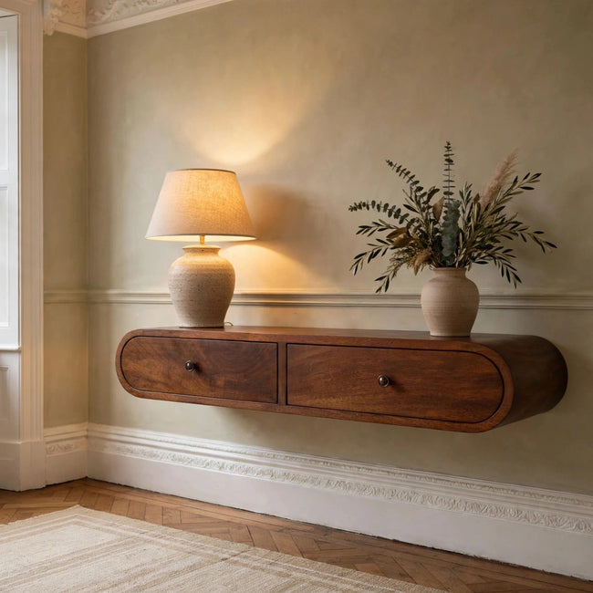 Curved floating chestnut console table in solid mango wood mounted on a hallway wall