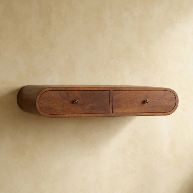 Wall-mounted chestnut console table with two drawers in a styled room