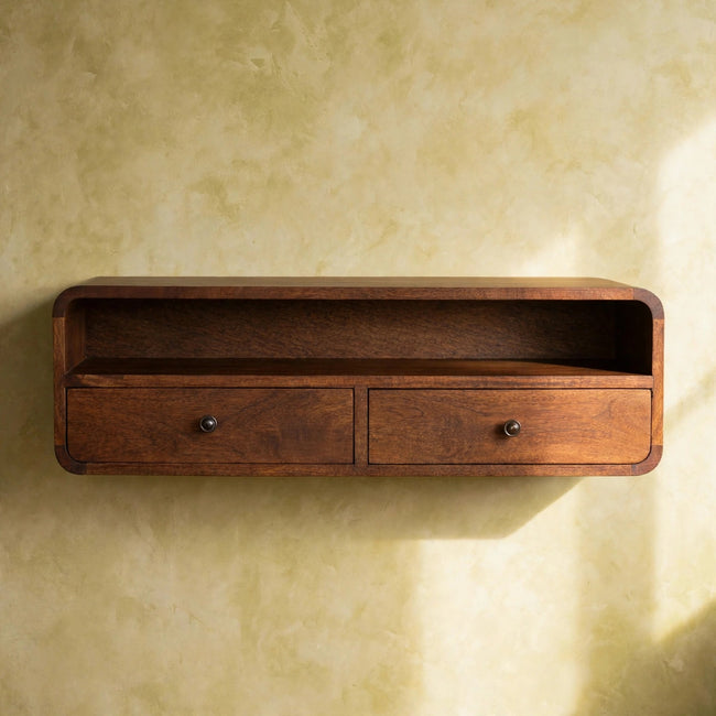 Curved wall-mounted console table with two drawers and an open shelf in a room setting