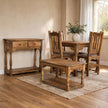 Solid mango wood dining table with four ladder-back chairs in a distressed finish, shown in a dining room