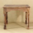 Side view of the mango wood dining table and ladder-back chairs