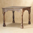 Ladder-back dining chairs pulled up to the solid mango wood table