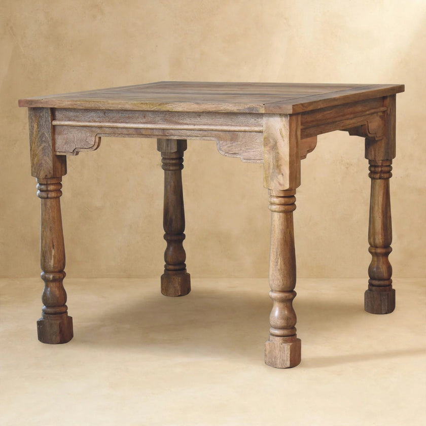 Ladder-back dining chairs pulled up to the solid mango wood table