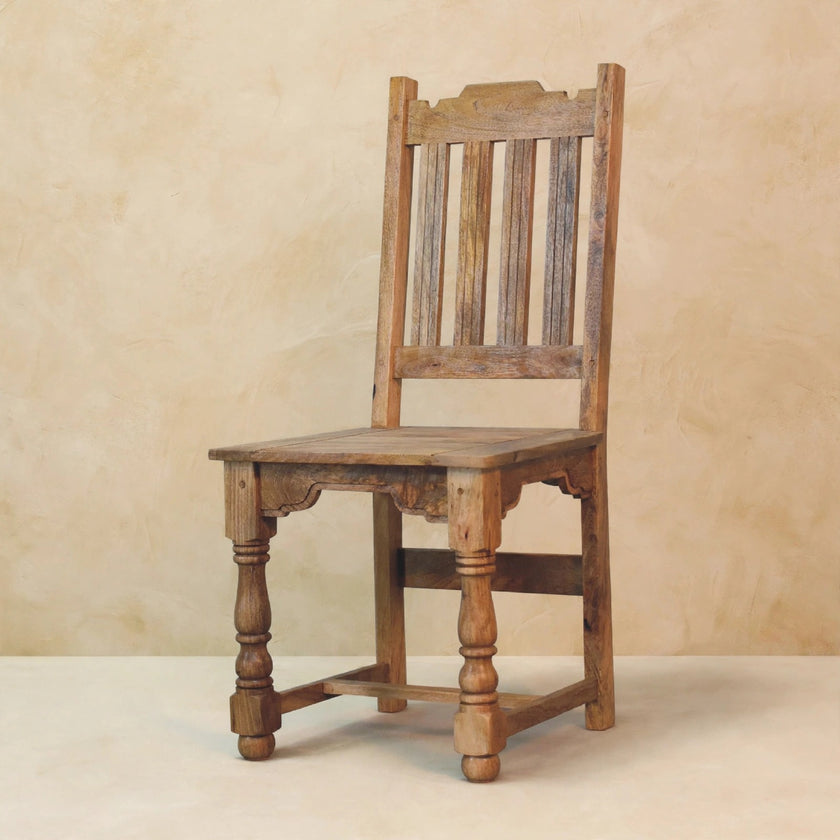 Dining chair with a ladder back and turned front legs next to the table