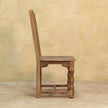 Four-chair mango wood dining set seen from a different angle in the room