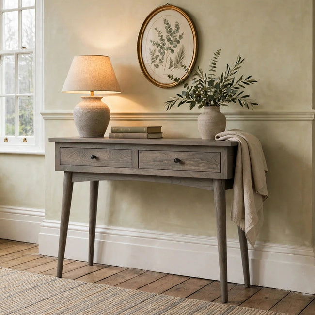 Two-drawer solid mango wood console table with oak-style finish in a hallway setting