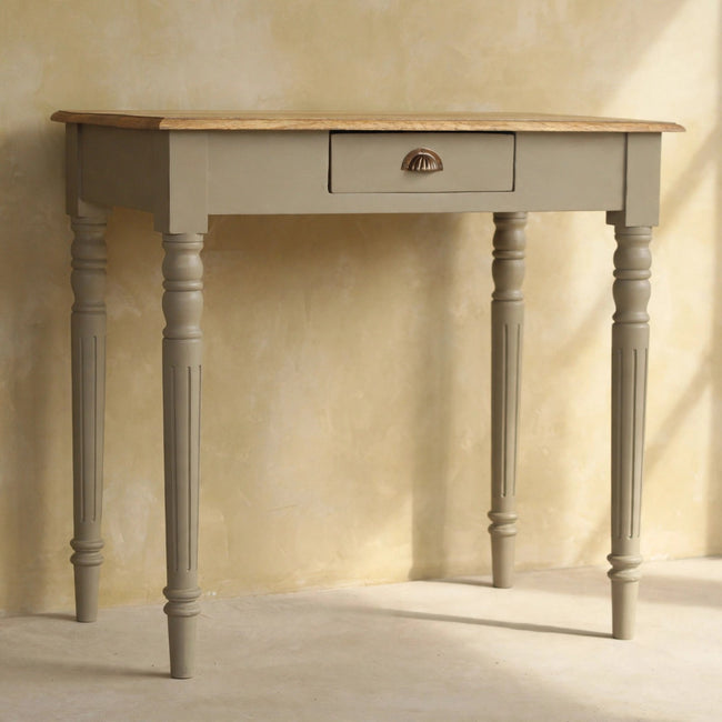 Front view of the solid mango wood writing desk with fluted legs in a styled room