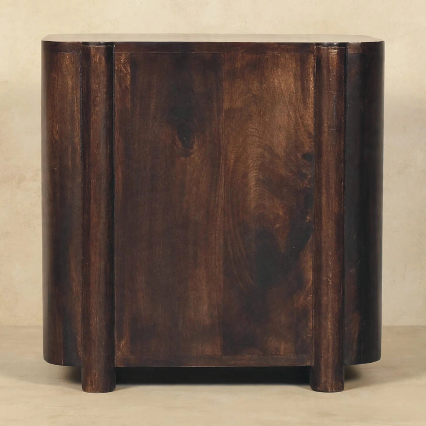 Havana rattan and mango wood chest of drawers in a warm, textured bedroom