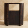 Havana nightstand with books on the open shelf in a bedroom