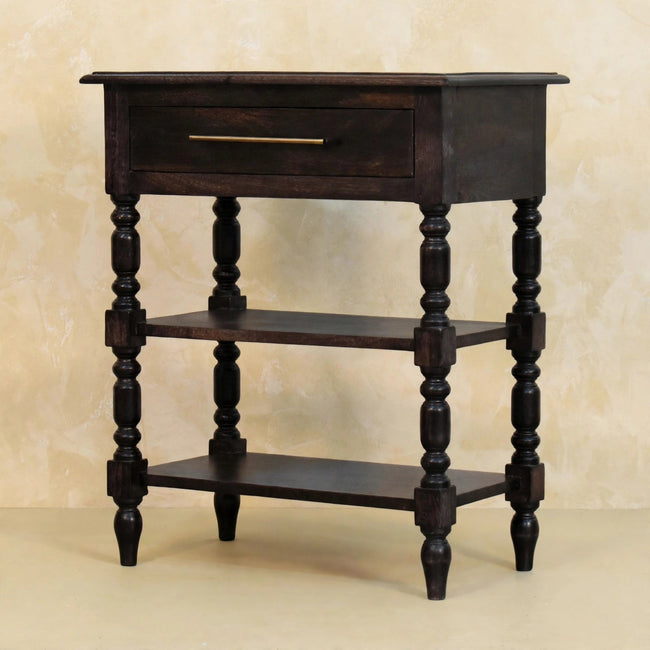Turned-leg side table in carbon ash finish placed beside a bed as a nightstand