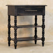 Side table in carbon ash finish styled with books and decor on the open shelves