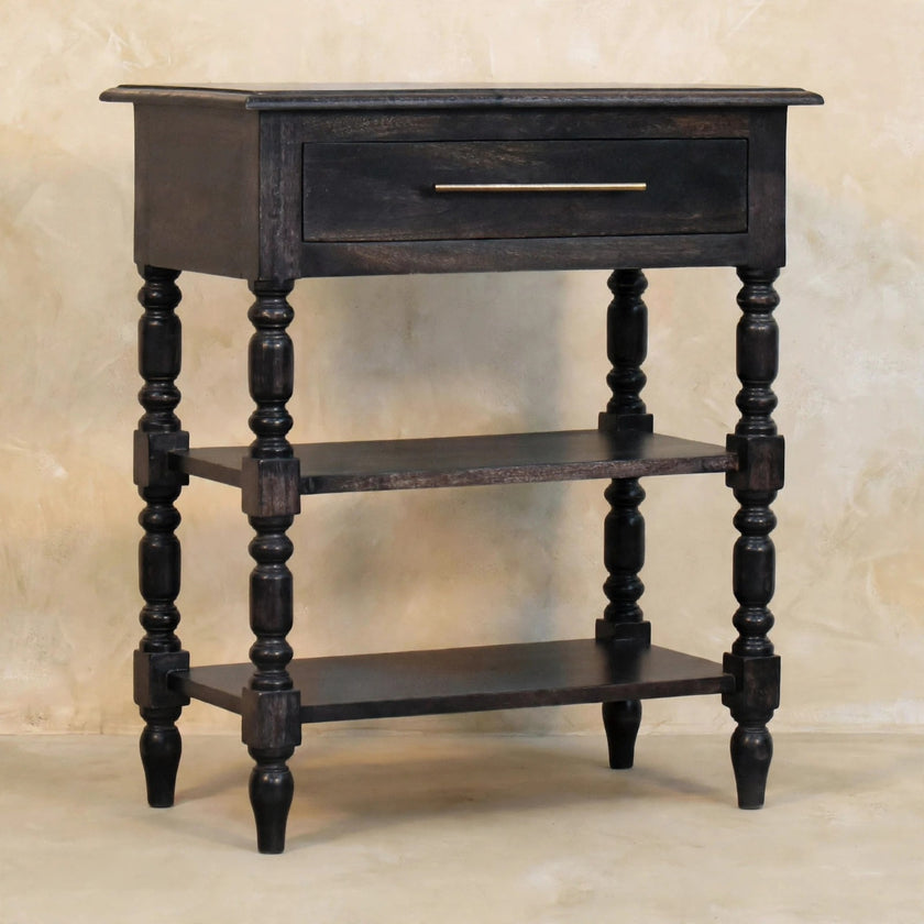Side table in carbon ash finish styled with books and decor on the open shelves