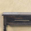Front view of the side table showing the drawer with brass-finished handle