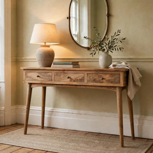 Oak-style mango wood console table with three drawers in a room setting