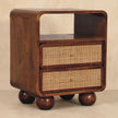 Close-up of the handwoven rattan drawer fronts on the chestnut nightstand