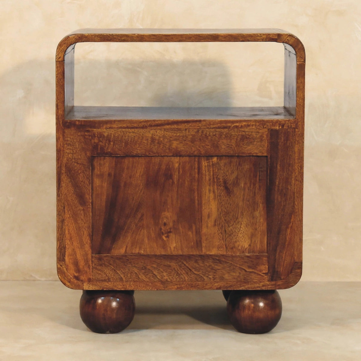Larissa chestnut nightstand in a styled bedroom, showing its rounded bun feet