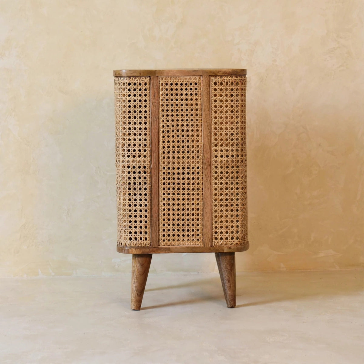 Larissa solid mango wood cabinet next to other furniture in a living space