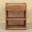 Oak-ish mango wood bedside table styled beside a bed