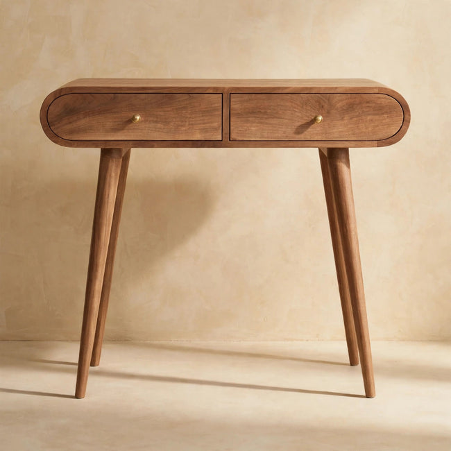 Mango wood console table with rounded edges and shiny drawer knobs in a hallway-style setting