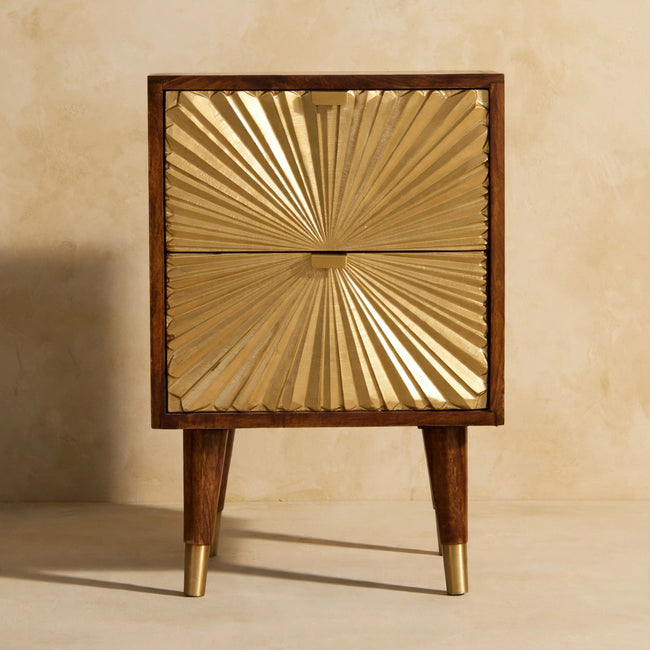 Manila Gold bedside table beside a bed, showing the chestnut finish and top surface