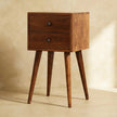 Mini 2 drawer chestnut bedside table in solid mango wood styled in a bedroom