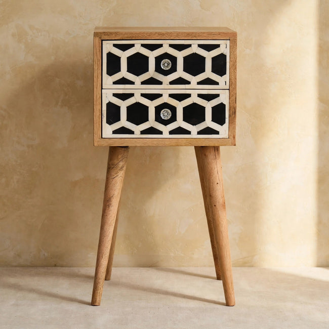 Mango wood bedside table with two bone inlay drawers next to a bed