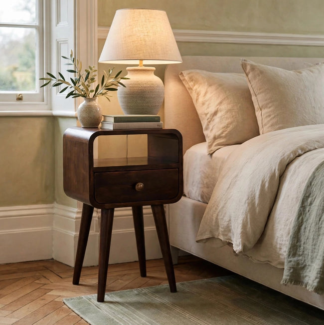 Mini California walnut bedside table with curved edges and an open slot, styled in a bedroom