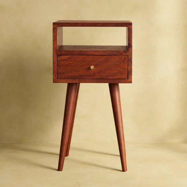 Cherry-finish mango wood bedside table with drawer and shelf, styled in a room setting