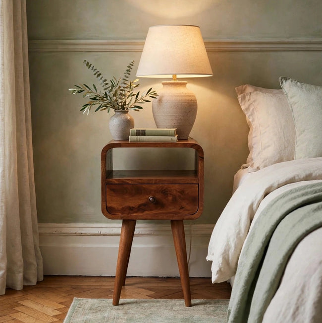 Mini chestnut mango wood bedside table with curved edges styled in a bedroom