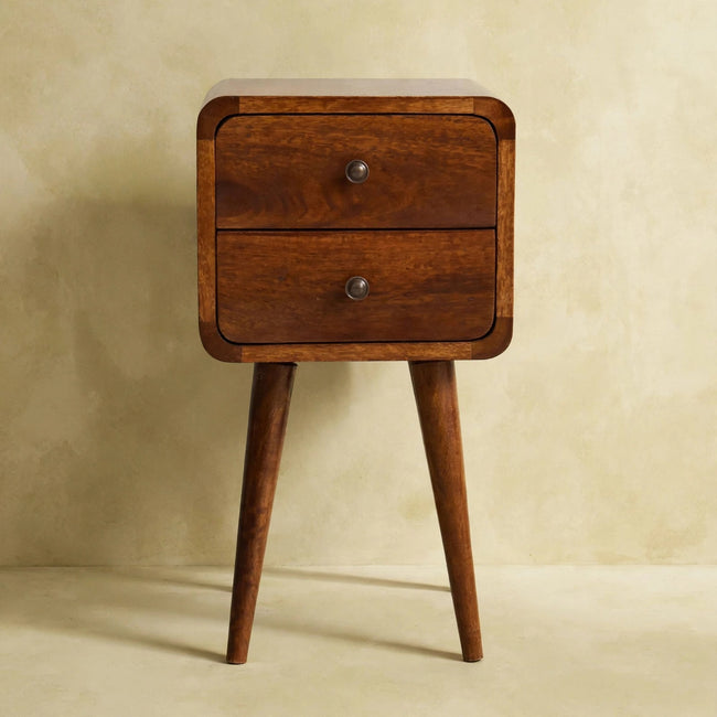 Curved solid mango wood bedside table with a lamp on top