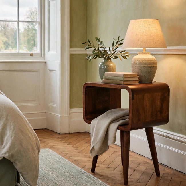 Mini chestnut mango wood bedside table with an open compartment in a bedroom
