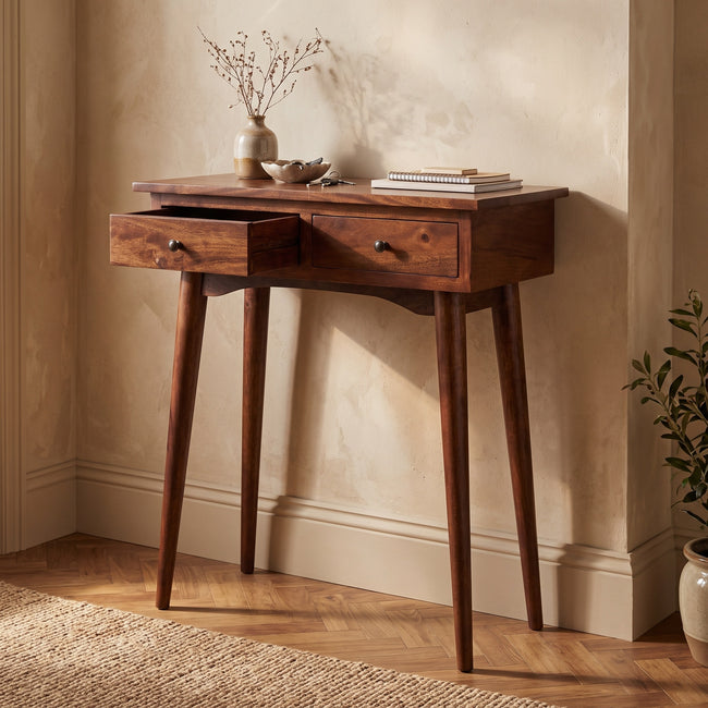 Mini chestnut mango wood console table with two small drawers, styled in a hallway