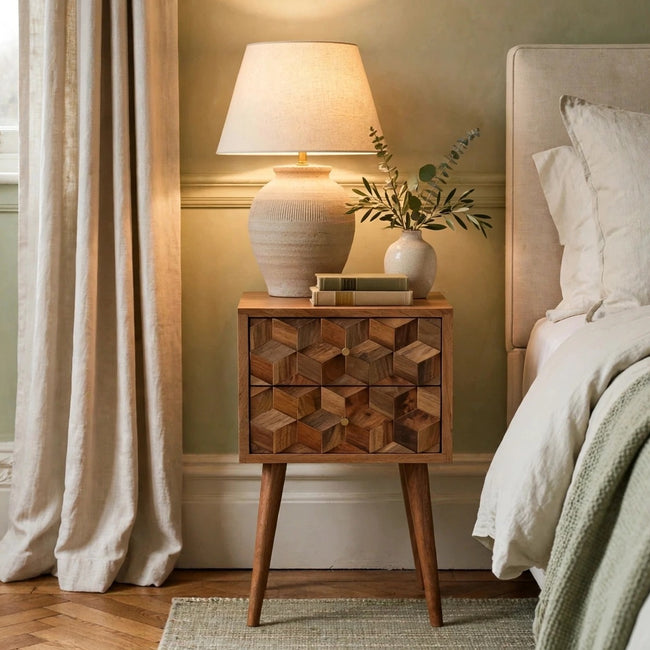 Mini cube carved 2 drawer mango wood bedside table styled next to a bed in a bedroom