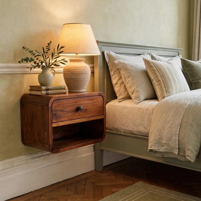Mini Curve floating bedside table in chestnut-finish mango wood mounted on a bedroom wall