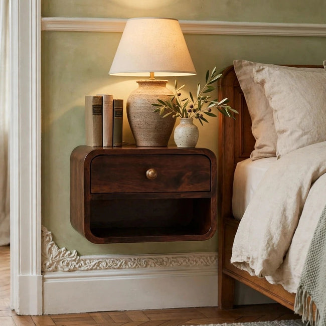 Mini wall mounted bedside table in California walnut finish with a drawer and open slot, shown in a bedroom