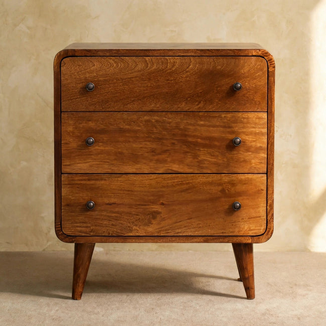Front view of the chestnut mini chest of drawers showing curved corners and shiny accent knobs