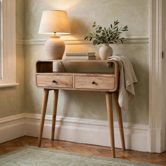 Mini curved console table in a natural oak-ish finish styled in a room