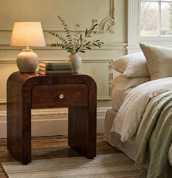 Mini Darcy chestnut mango wood nightstand with curved edges styled in a bedroom