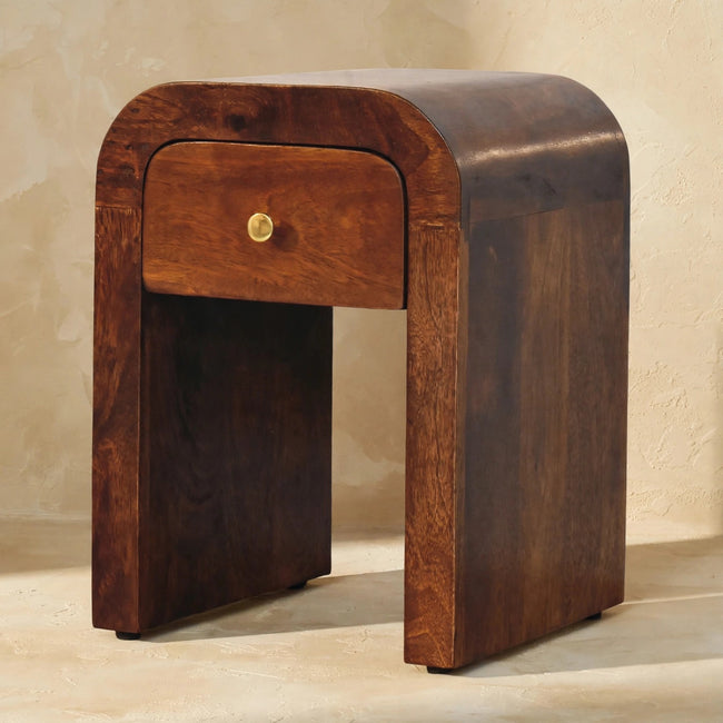 Chestnut bedside table with a single drawer and brass knob in a room setting