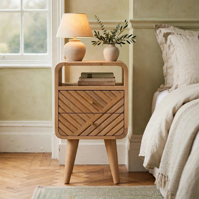 Mini Lille curved bedside table in oak-ish solid mango wood styled in a bedroom