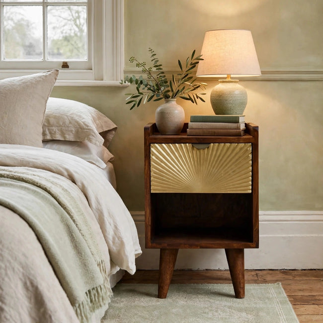 Mini Manila Gold mango wood bedside table with a brass-plated drawer in a bedroom