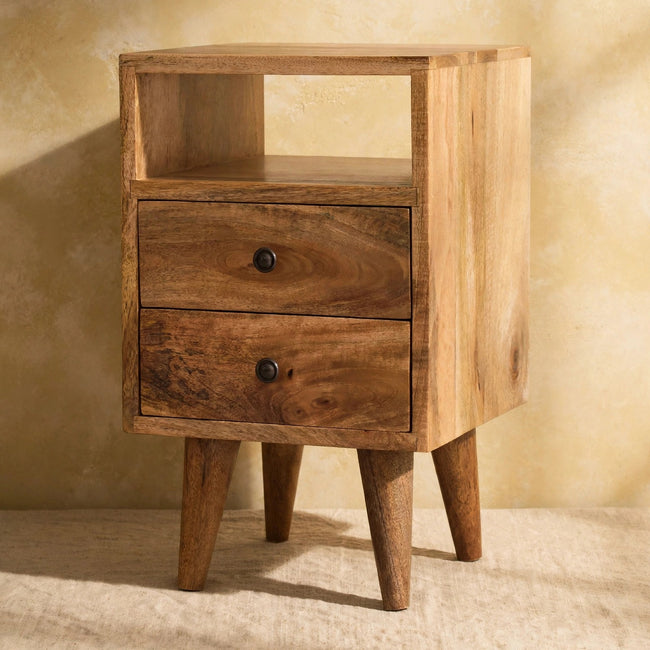 Mango wood bedside table with an open slot and Nordic-style legs, styled in a room
