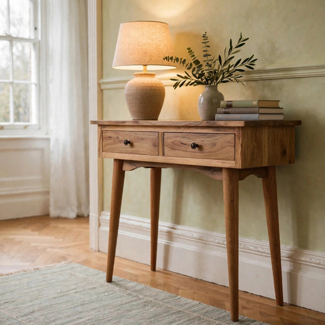 Small solid mango wood console table with two drawers standing in a hallway
