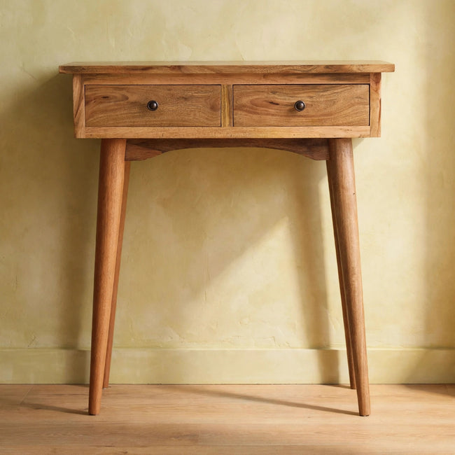 Oak-ish hallway console table placed against a wall in a styled room