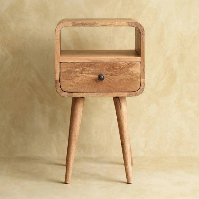 Small bedside table with curved edges, a drawer and an open slot, styled in a room