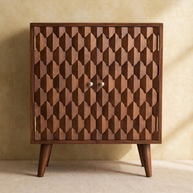Front view of the mango wood cabinet showing the pineapple carving and shiny knobs