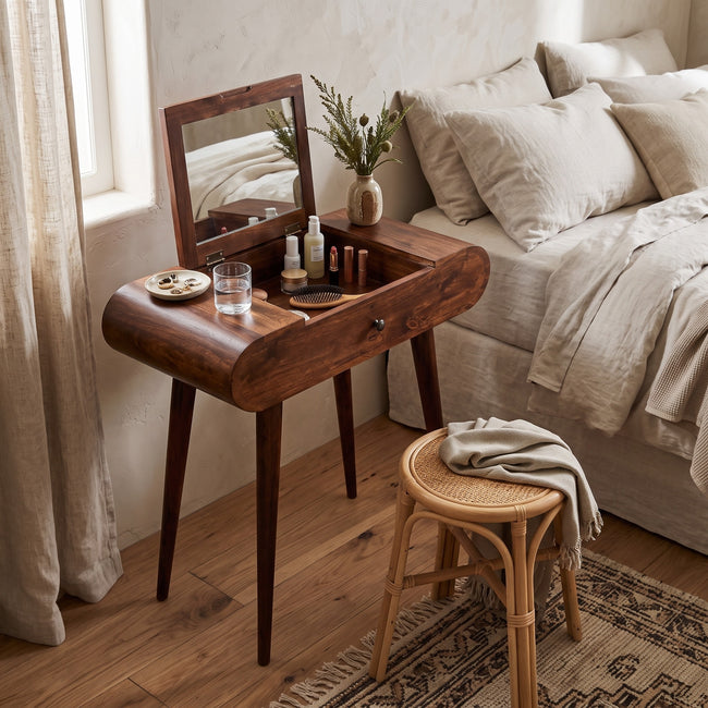Mini round chestnut vanity table in solid mango wood styled in a bedroom